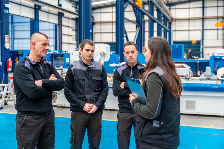 team-industrial-technicians-talking-standing-facilities_242111-35384